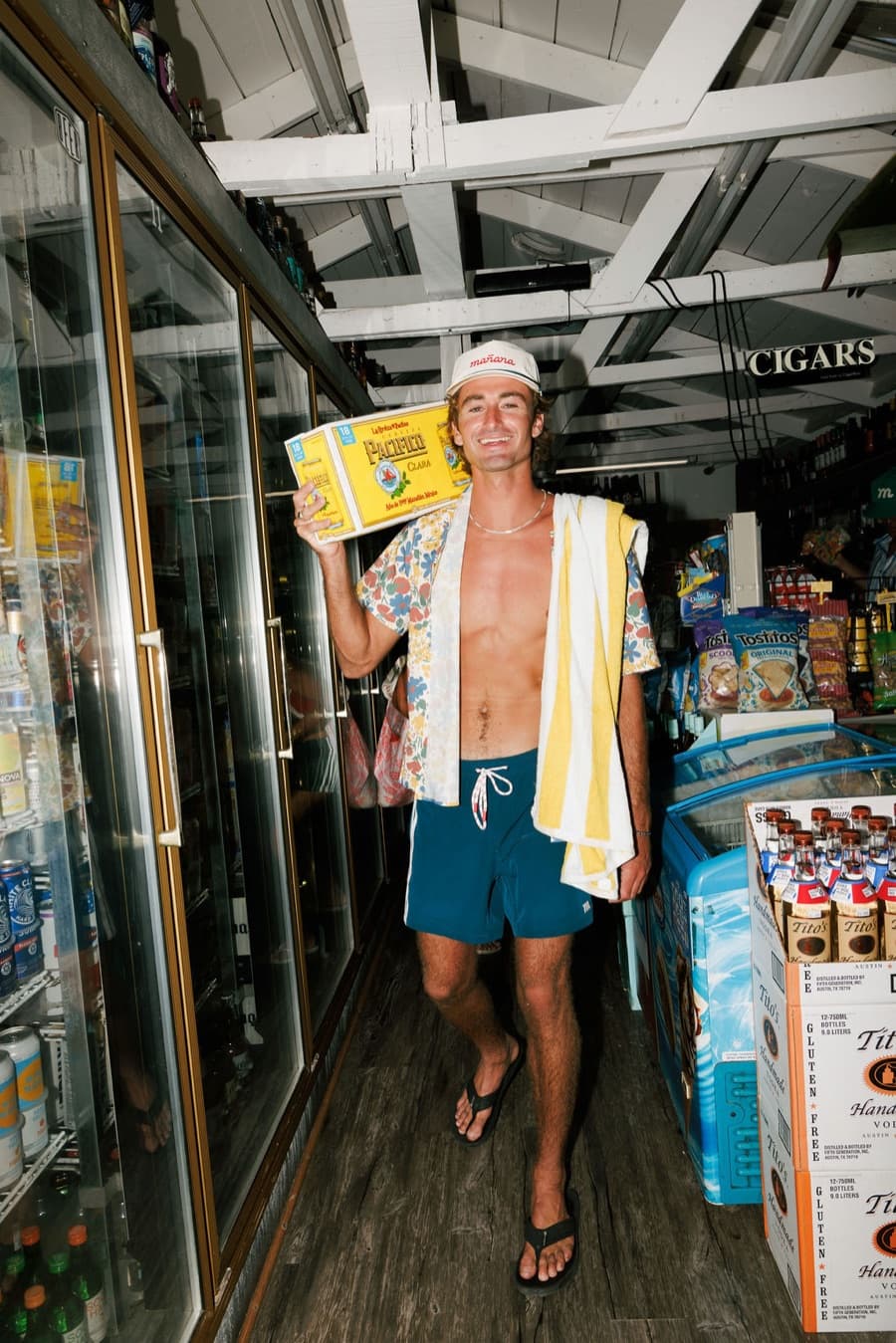 Carrying a case of beer out of the corner store in a Breeze shirt and Volley shorts